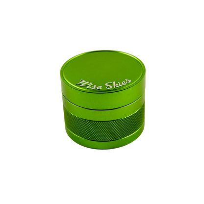 Green metal grinder with 'Wise Skies' branding on a white background