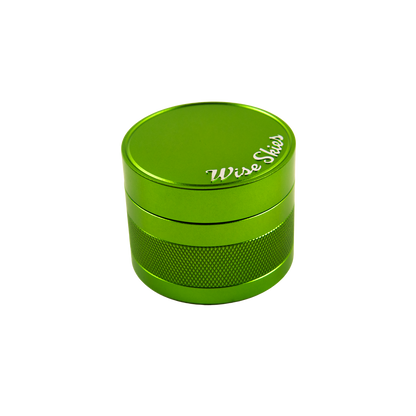 Green metal grinder with 'Wise Seeds' branding on a white background