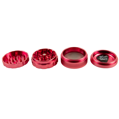 Red metal grinder with four parts on a white background