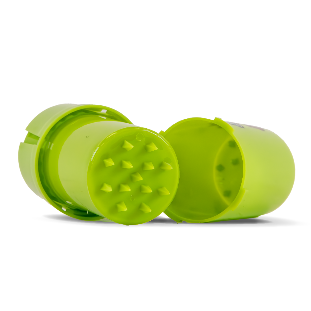 Green herb grinder with two parts on a white background