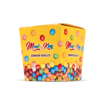 Yellow box of Monkey King Choco Balls with colorful candy balls on a white background